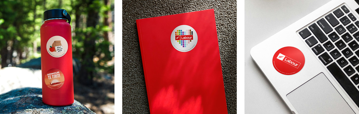 Labour Party stickers on a laptop, drink bottle and book cover.