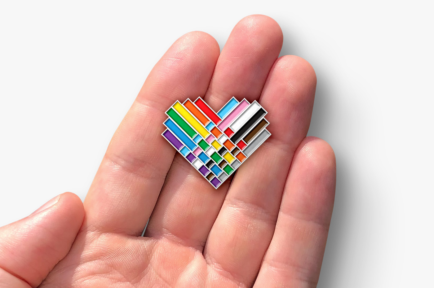 The final logo design for the 2020 Wellington Pride Festival as a pin button badge mockup
