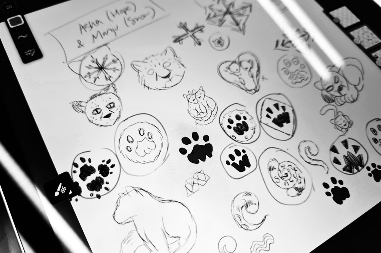 An iPad displaying my various sketches, illustrations, drawings and concept art for the snow leopard pins for Wellington Zoo