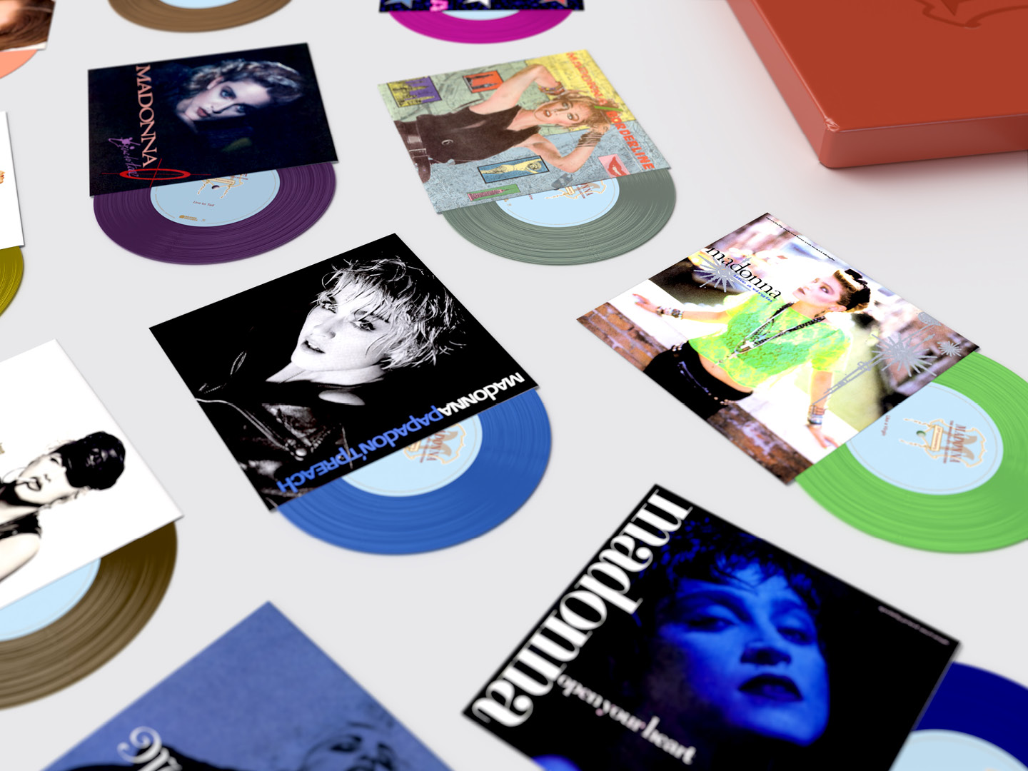 Madonna "The Immaculate Collection" box set design, close up of Open Your Heart, Papa Don't Preach and Like a Virgin 7" coloured vinyl singles